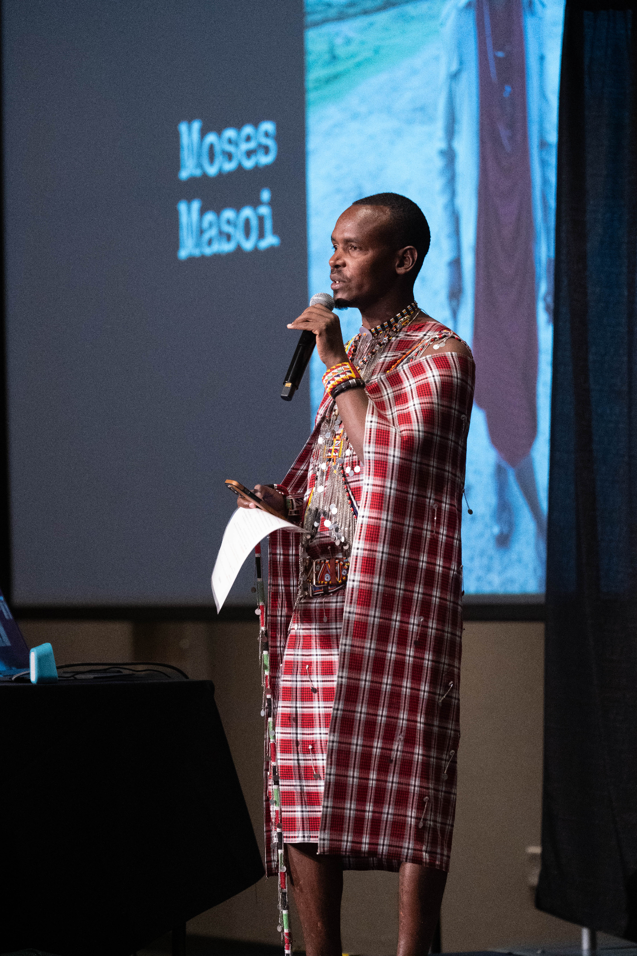Moses Masoi speaking on stage