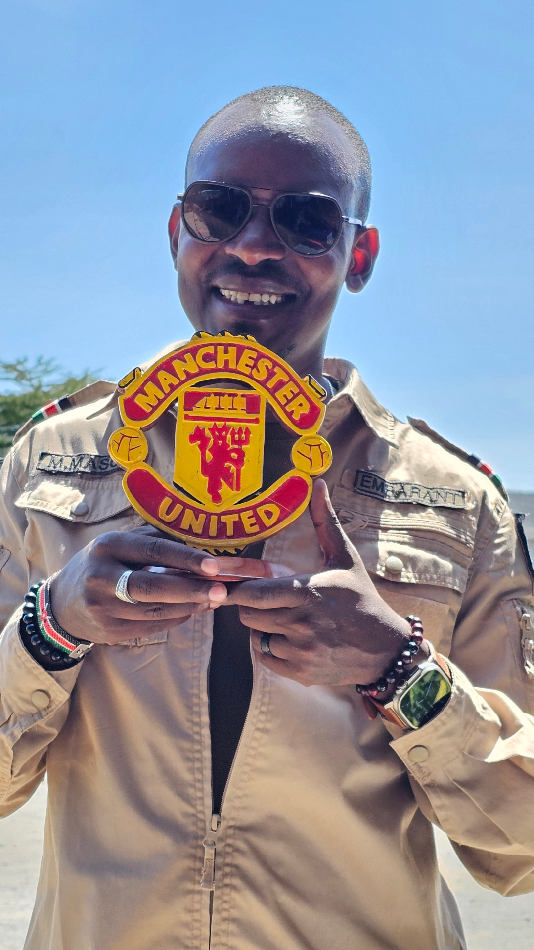 Moses Masoi holding a Manchester United crest