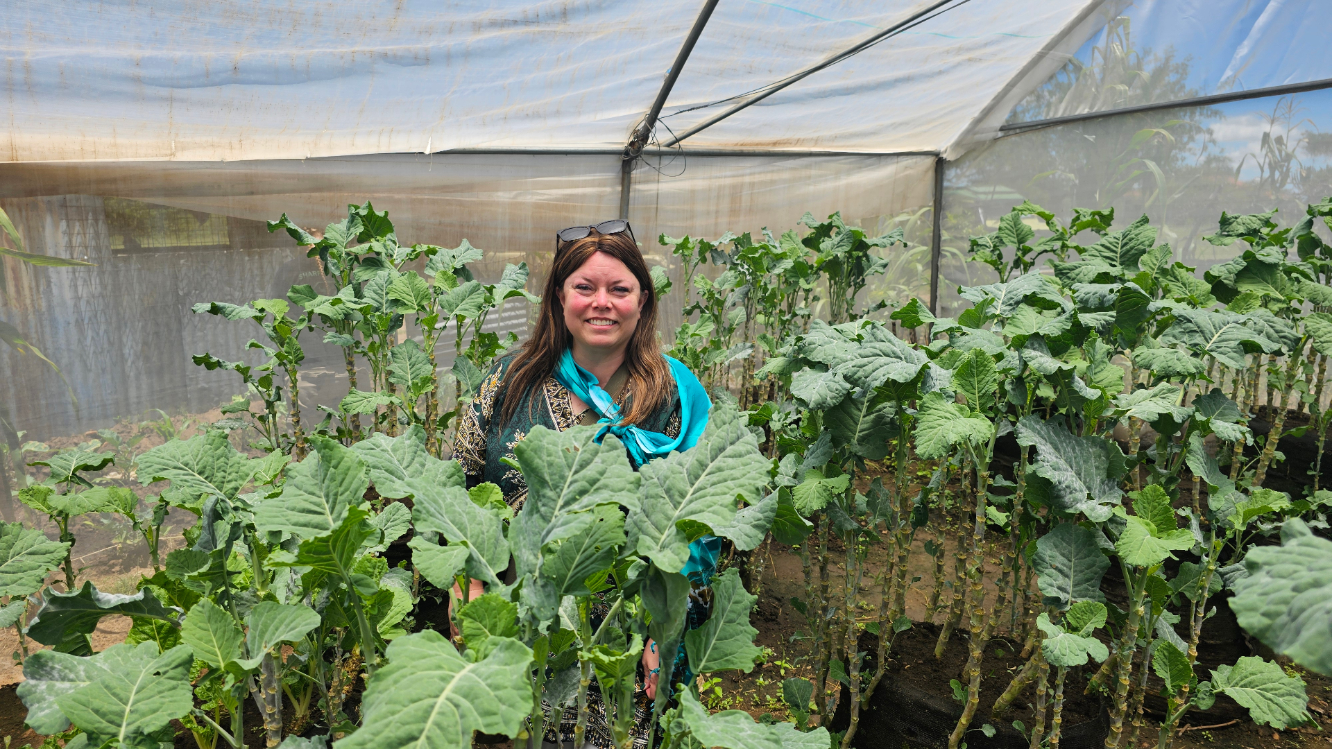 Heidi Totten inside a greenhouse of Garden Towers in Kenya