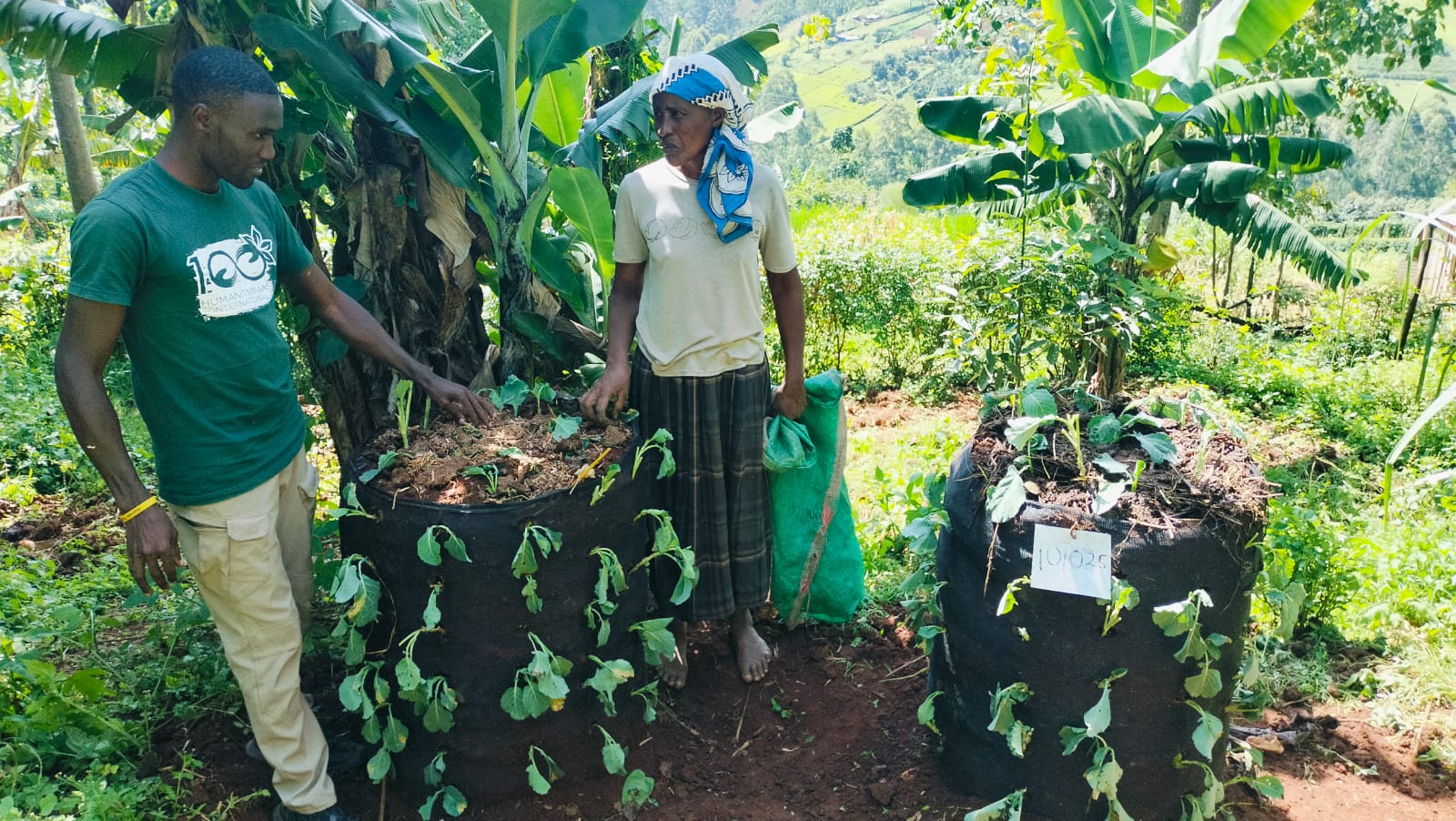 100 Humanitarians team member planting a Garden Tower with a woman in Bomet, Kenya