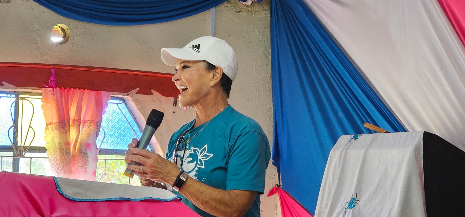 Mary Crafts, co-founder of 100 Women of Hope, speaking at a community event in Kenya