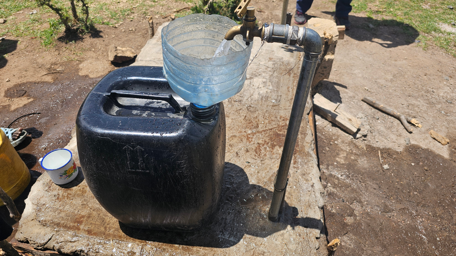 A protected spring in rural Kenya delivering clean water through a controlled outlet pipe