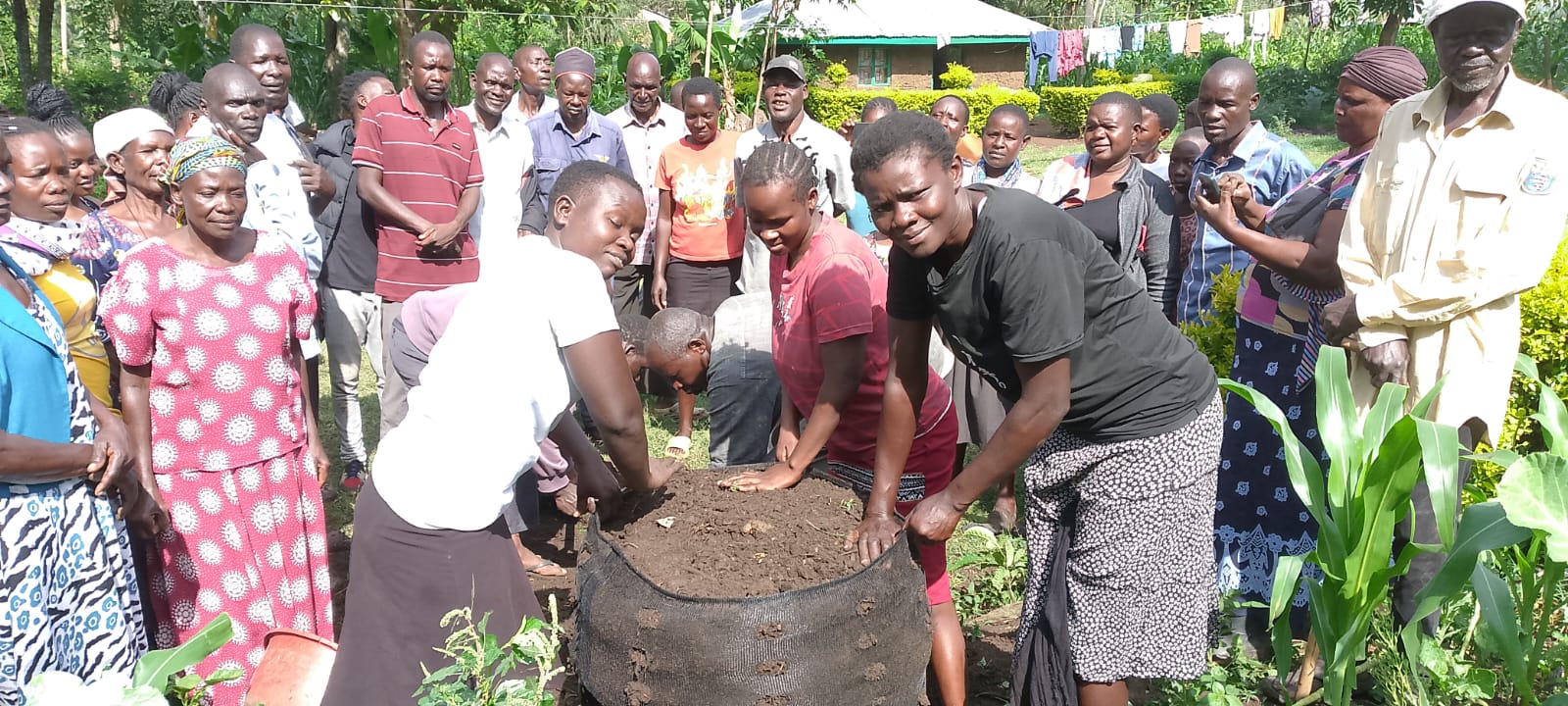 Community members building a Garden Tower together